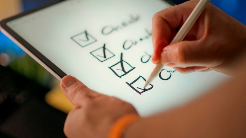 Hand marking items on a checklist